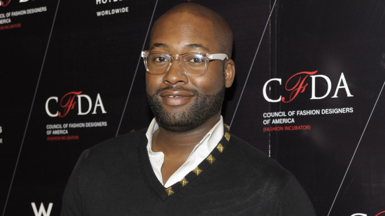 Mychael Knight smiling on step-and-repeat for the Council of Fashion Designers event