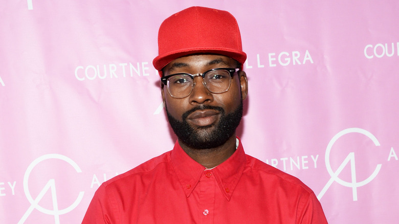 Mychael Knight posing on step-and-repeat for Courtney Allegra VIP store opening