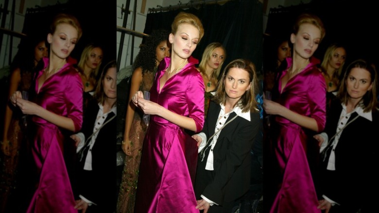 Wendy Pepper holding the fabric of the pink dress worn by model