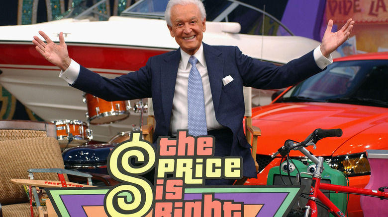 Bob Barker posing behind a "The Price is Right" sign