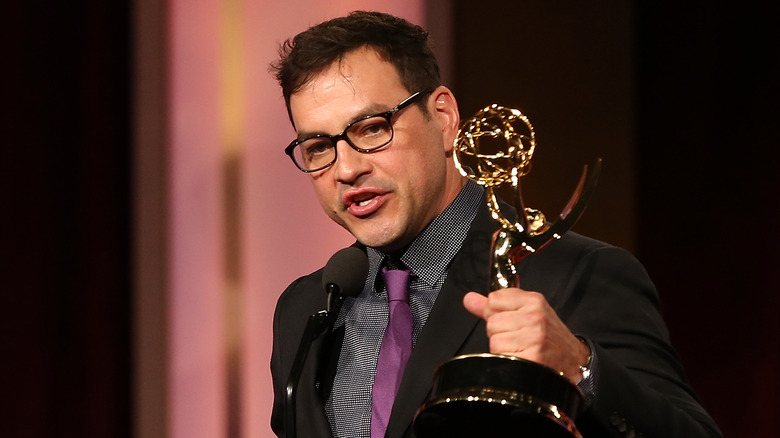 Tyler Christopher smiling and holding his Emmy Award