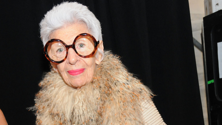 Iris Apfel in trademark glasses and fuzzy boa