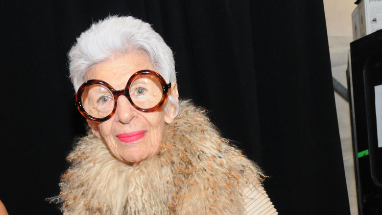 Iris Apfel in trademark glasses and fuzzy boa