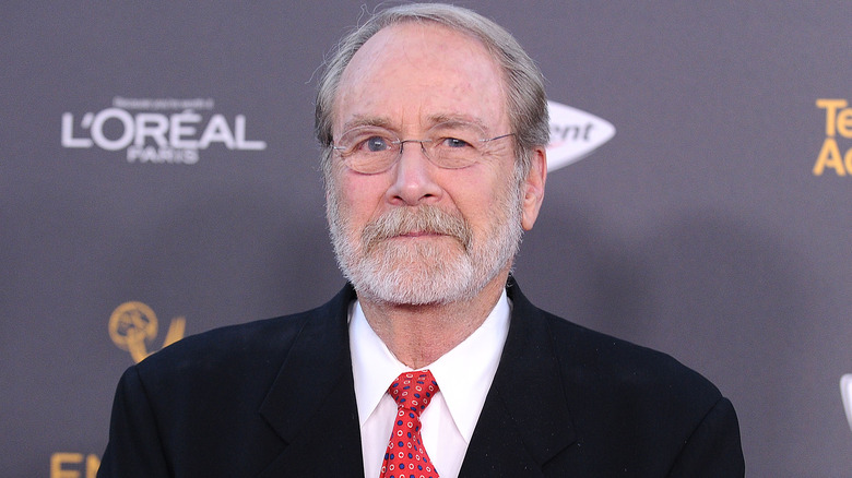 Martin Mull, gray hair, mustache, red tie