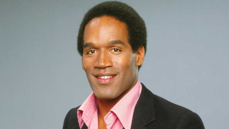 Younger OJ Simpson in pink shirt