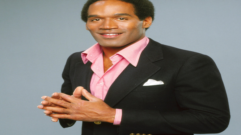 Younger OJ Simpson in pink shirt