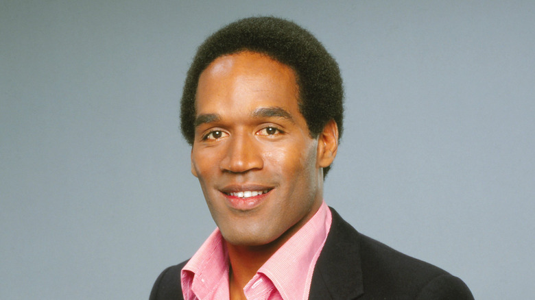 Younger OJ Simpson in pink shirt