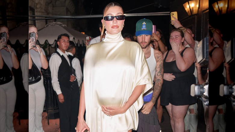 Hailey Bieber pregnant in a white dress Justin Bieber walking behind her