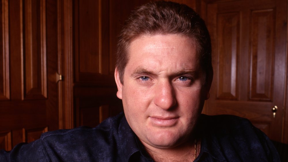 Chris Penn in front of a wooden wall