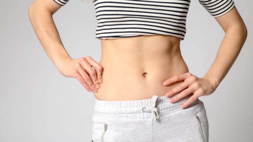 A woman with a small waist wearing a crop top