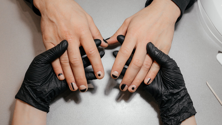 Woman getting negative space manicure