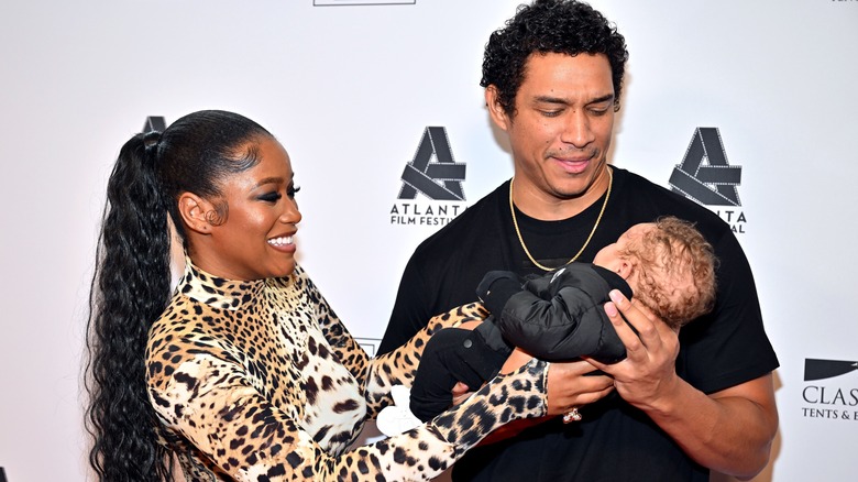 Keke Palmer and Darius Jackson holding their son