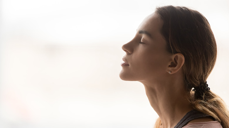 Woman taking a deep breath