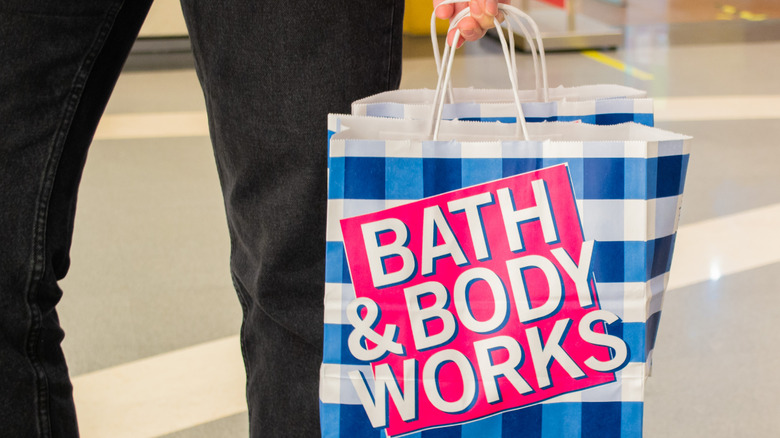 Shopper carrying a Bath & Body Works bag