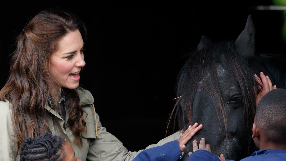 Kate Middleton with kids petting a horse