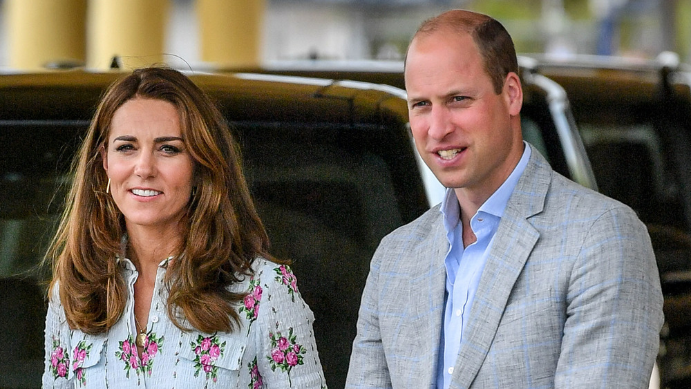 Kate Middleton and Prince William in front of a car