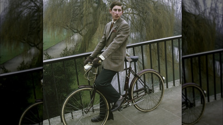 King Charles sitting on bicycle