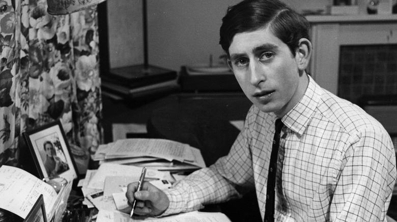 Prince Charles posing at desk