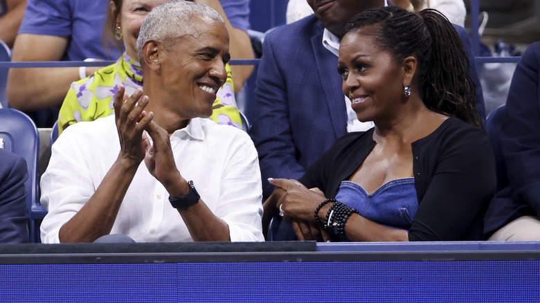 Michelle Obama and Barack Obama grinning at each other