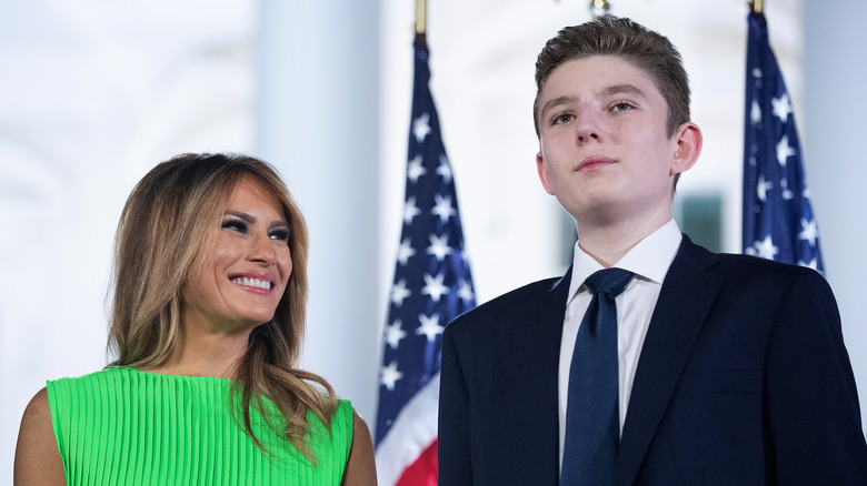 Melania Trump onstage with Barron in front of several American flags