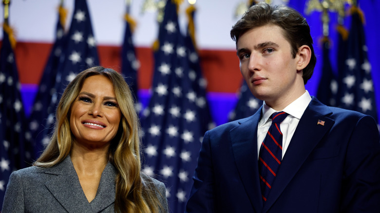 Melania Trump onstage with Barron in front of several American flags