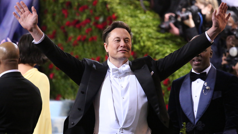 Elon Musk with arms out at the 2022 Met Gala