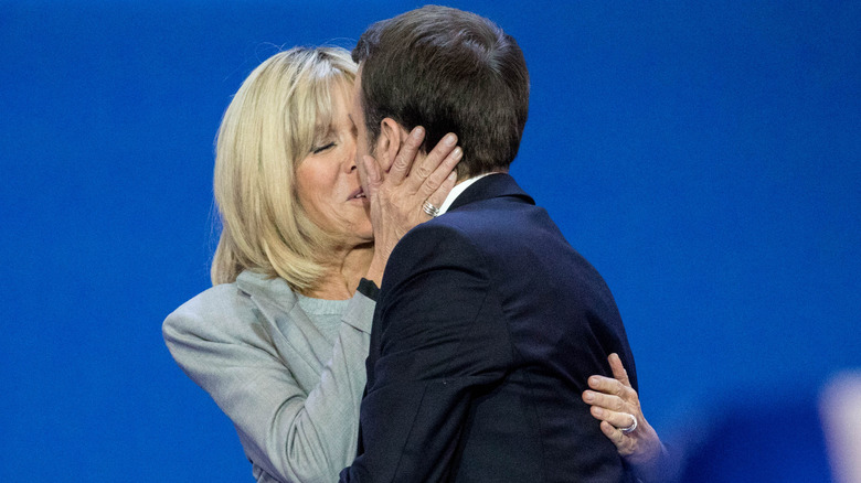 The Macrons embracing and kissing