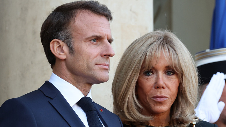 The Macrons with serious expressions