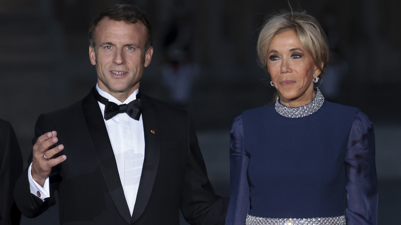 Macrons in formal attire, his hand raised while speaking