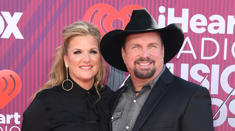 Garth Brooks and Trisha Yearwood smiling at the camera