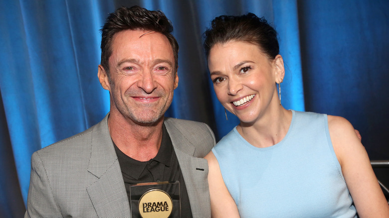 Hugh Jackman and Sutton Foster smiling with Drama League award