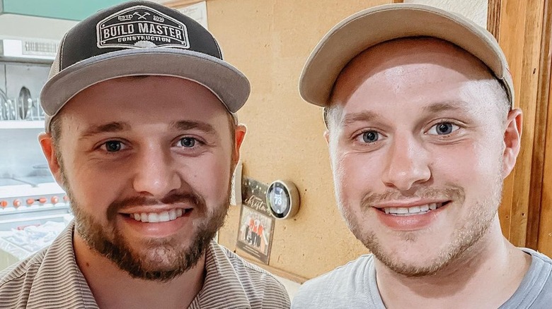 Jason and Josiah Duggar wearing baseball caps