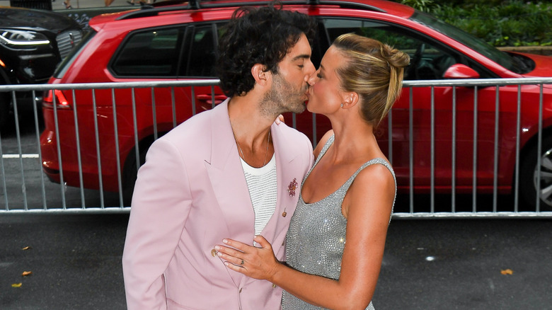 Justin Baldoni and Emily Baldoni kissing