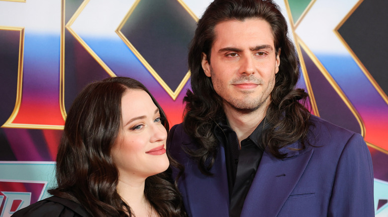 Andrew W.K. and Kat Dennings posing together on red carpet