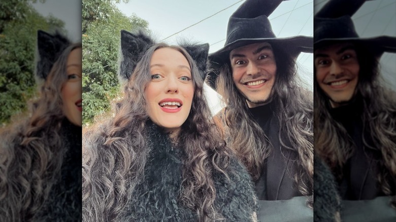 Kat Dennings and Andrew W.K. posing i cat ears and a witches hat