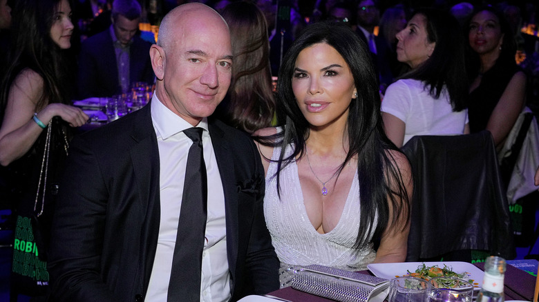 Lauren Sánchez and Jeff Bezos sitting and posing for photos