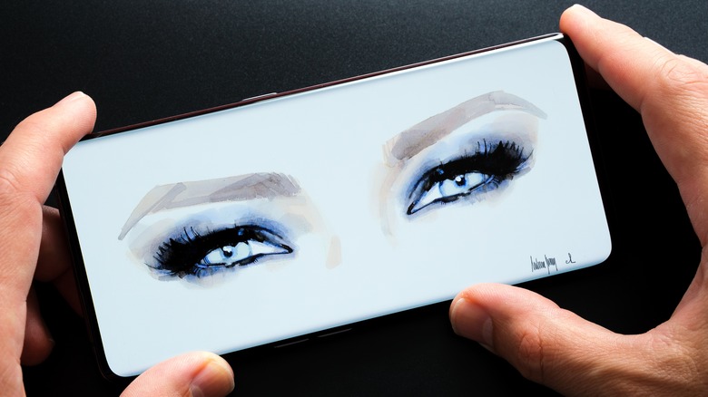 painting of Melania Trump's eyes on phone