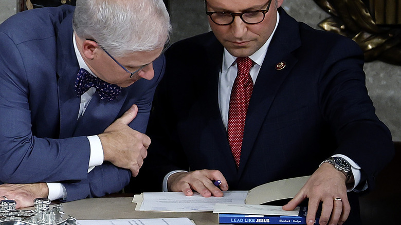 Mike Johnson looking at documents