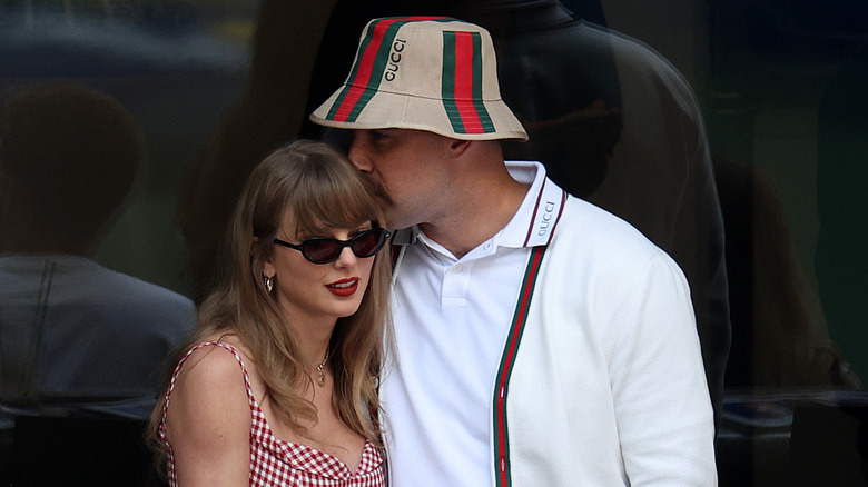 Travis Kelce kissing Taylor Swift's head