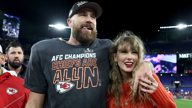 Travis Kelce with arm around Taylor Swift