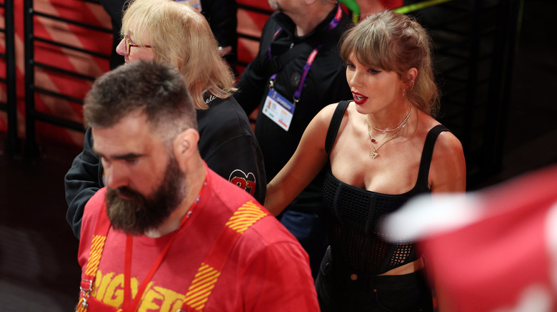 Jason and Donna Kelce walking with Taylor Swift