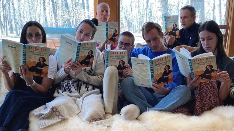 Demi Moore and Bruce Willis reading with their family