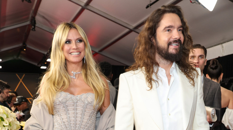 Heidi Klum and Tom Kaulitz smiling and walking at the 67th GRAMMY Awards at Crypto.com Arena on February 02, 2025 in Los Angeles, California