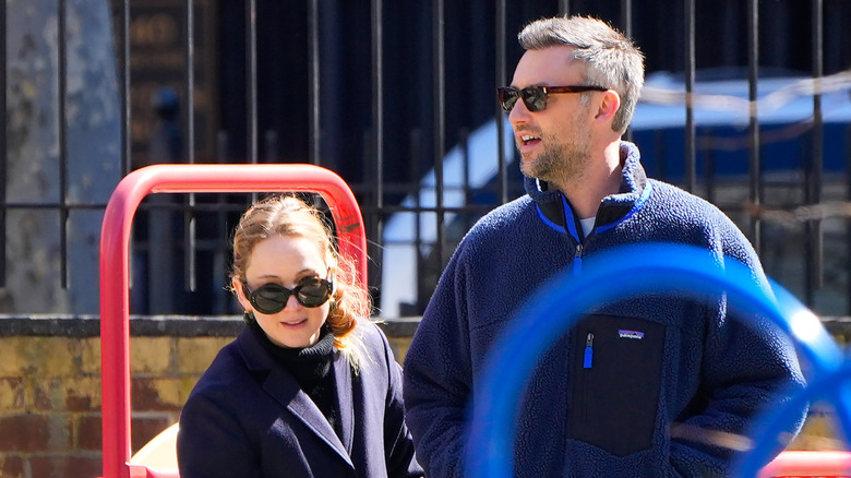 Jennifer Lawrence and Cooke Maroney on playground while wearing sunglasses.