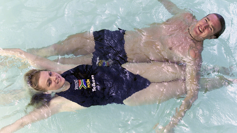 Young Princess Charlene posing in water with man