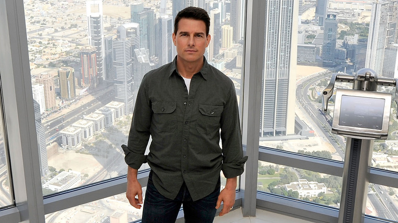 Tom Cruise posing on the 124th floor of the Burj Khalifa building