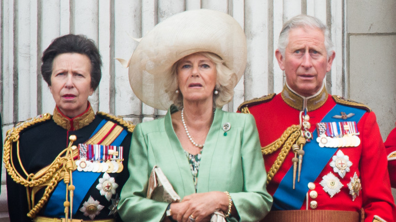 King Charles, Queen Camilla, and Princess Anne posing 