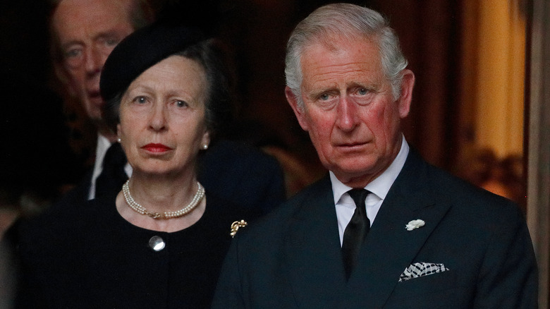 King Charles and Princess Anne standing together 