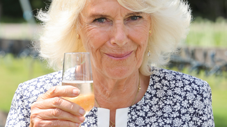 Queen Camilla holding wine glass