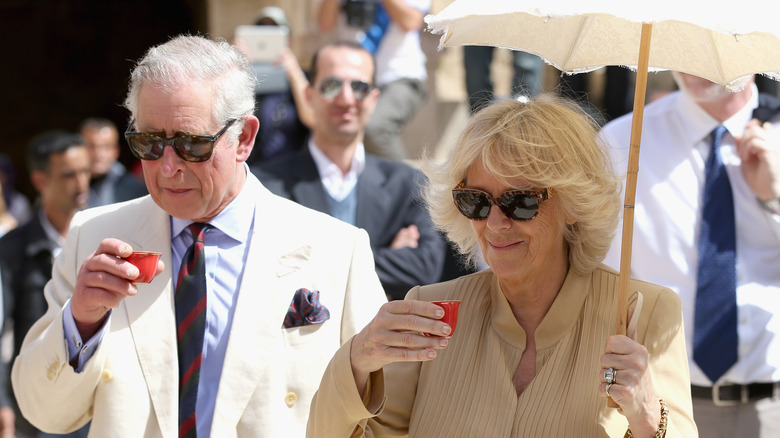 King Charles and Queen Camilla drinking 